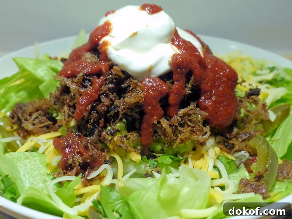 Salad with pork carnitas, sour cream and salsa