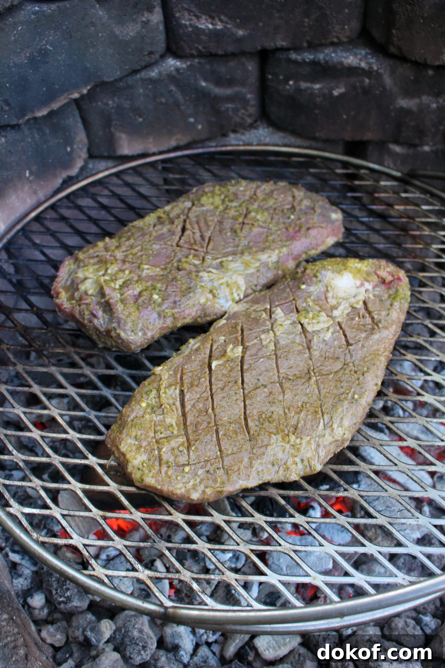 The marinaded flank steak getting started over the fire. 