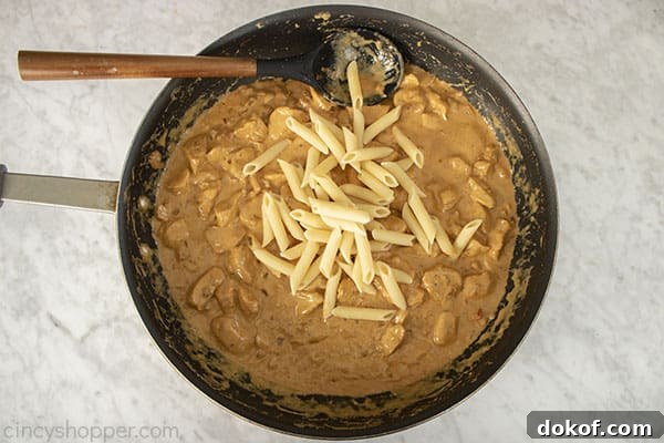 Cooked pasta added to spicy alfredo