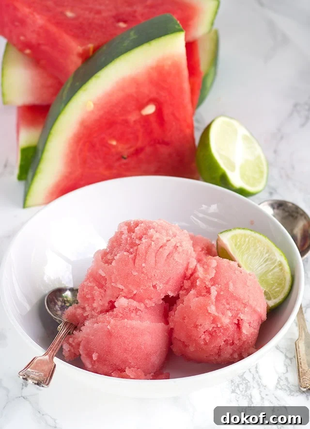 overhead image of a bowl of Watermelon Sorbet next to fresh watermelon slices