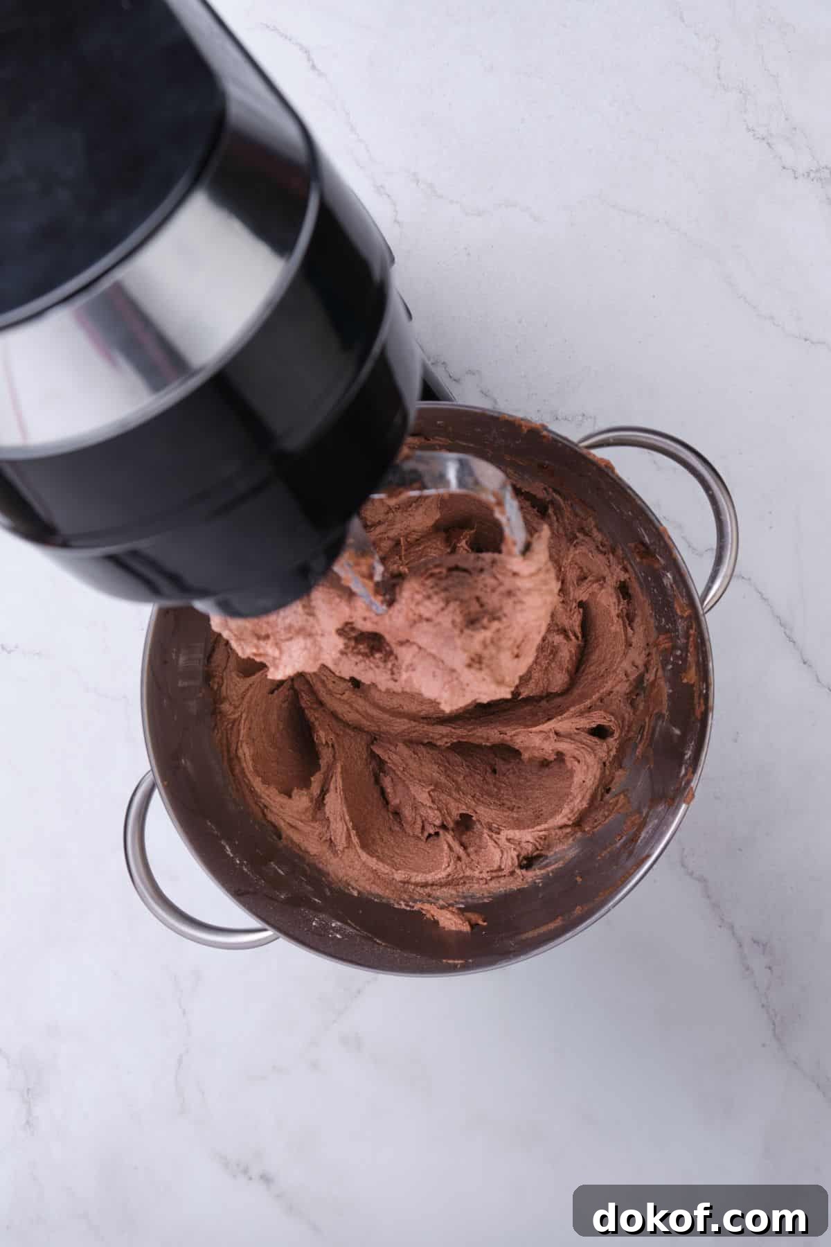 Chocolate buttercream in a stand mixer.