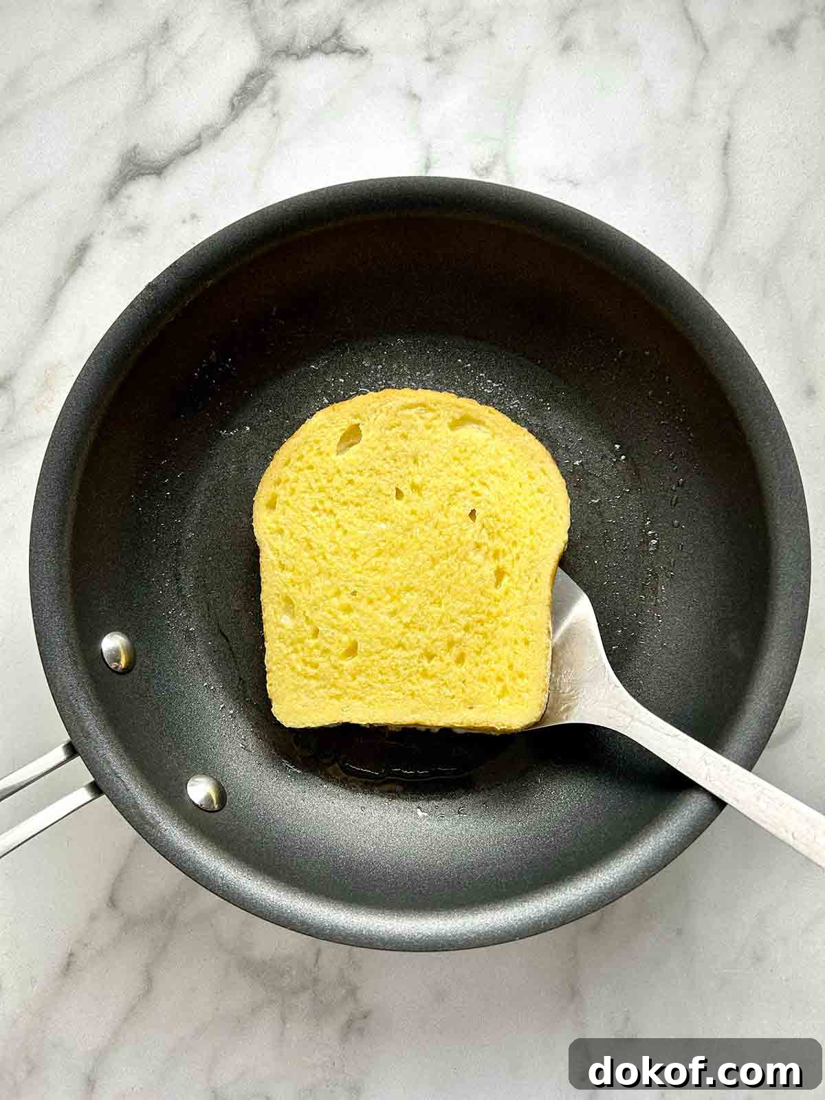 frying first side of bread on pan