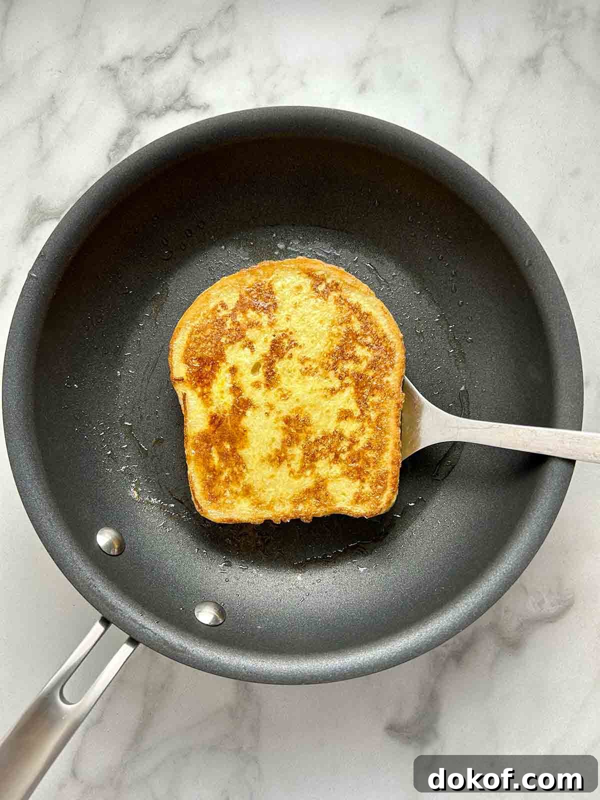 frying second side of bread on pan