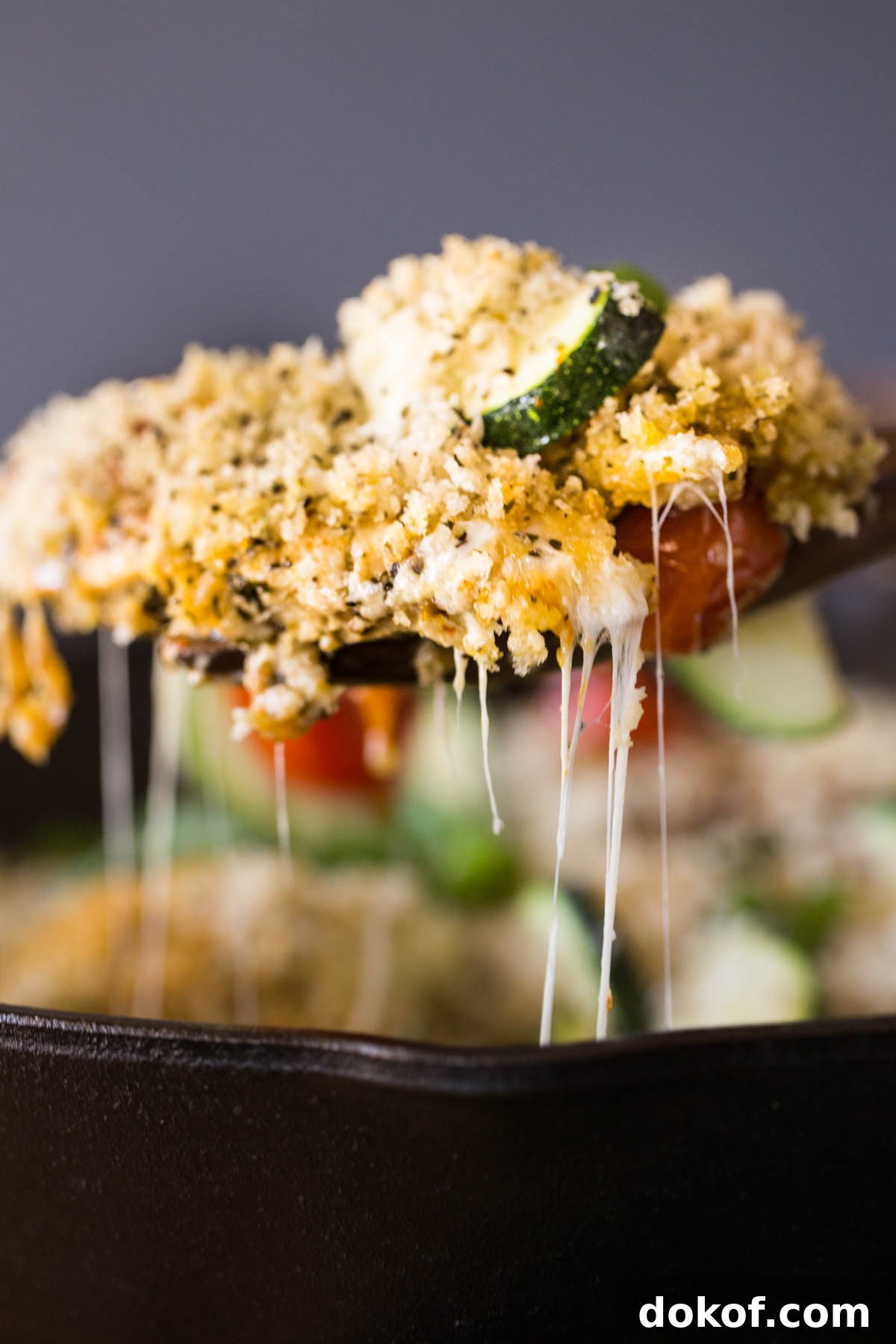 A serving spoon full of the Pesto Chicken Skillet.  