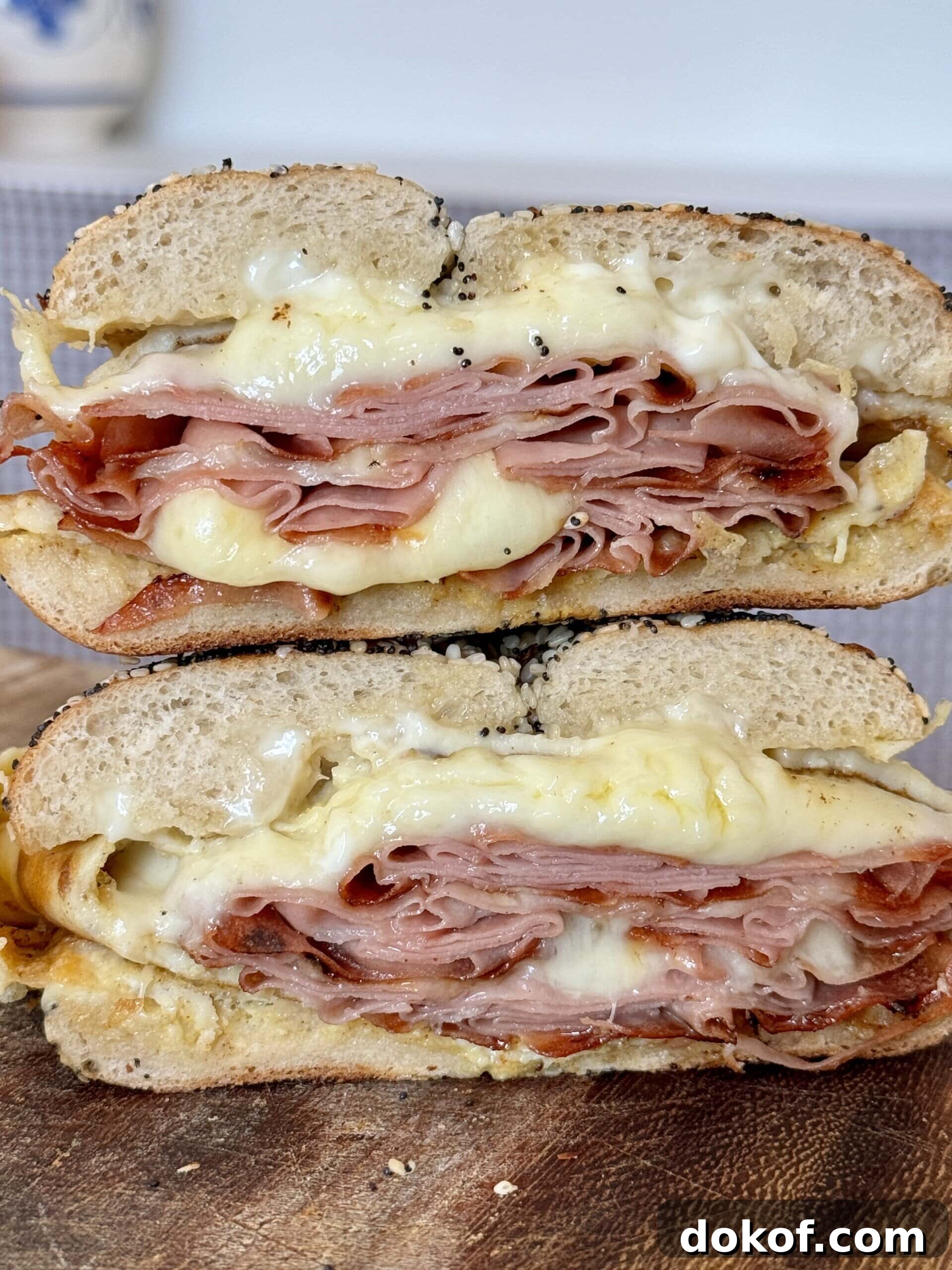 Morning Bagel Sandwich Recipes for Quick, Flavorful Breakfasts 2 breakfast bagels sandwiches stacked up.