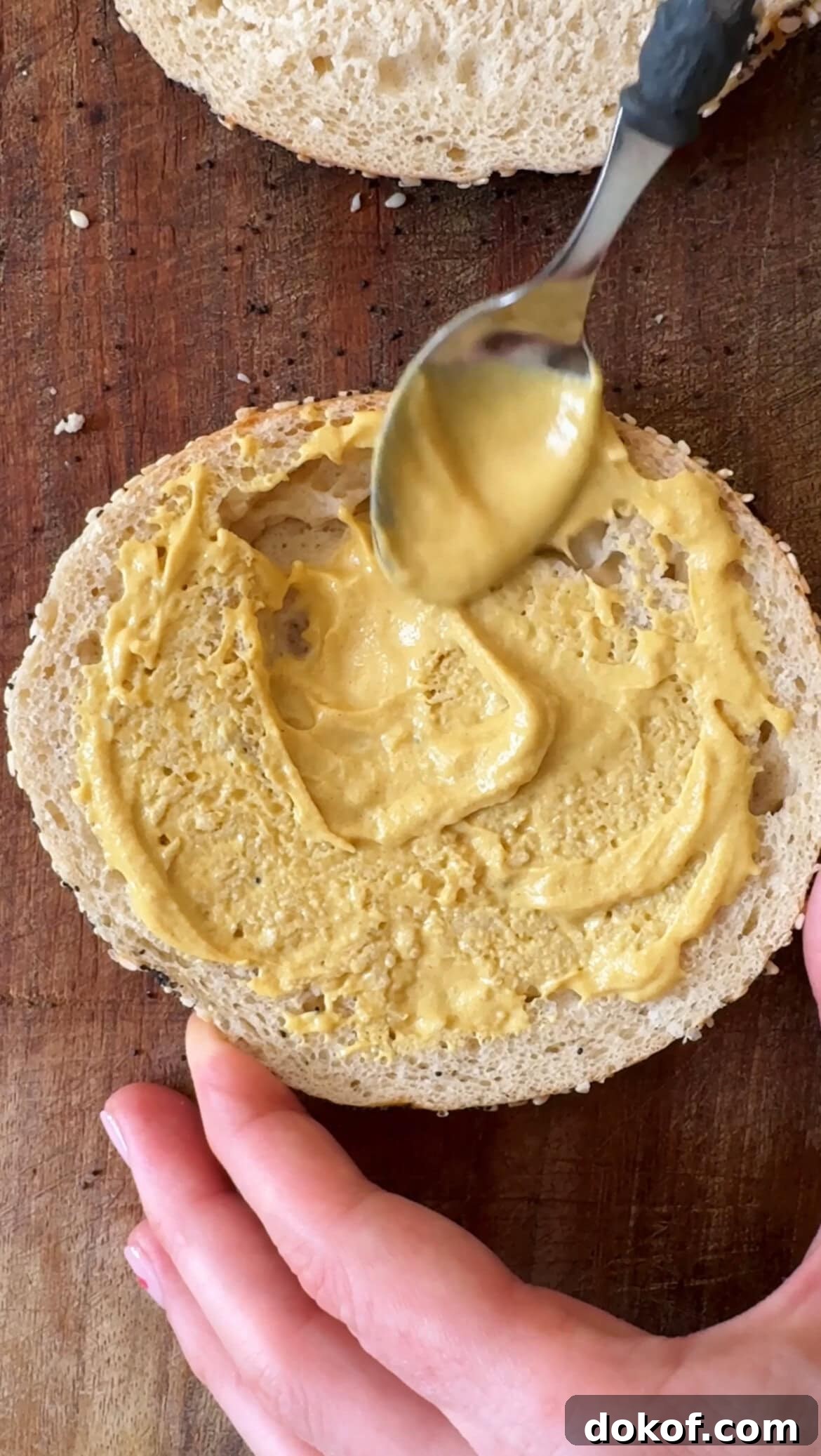Morning Bagel Sandwich Recipes for Quick, Flavorful Breakfasts 5 spreading mustard on bagel.