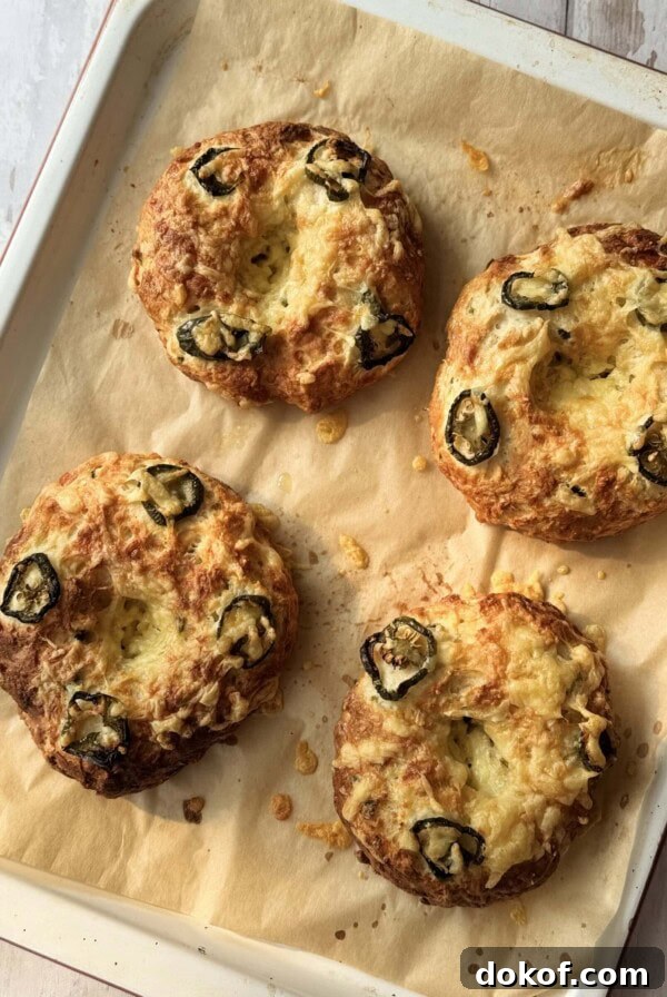Morning Bagel Sandwich Recipes for Quick, Flavorful Breakfasts 10 3 ingredient bagel with cheese and jalapeno on a tray.