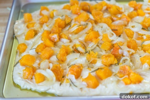 Butternut Squash Cubes and Rosemary on Raw Focaccia Dough
