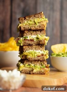 4 sandwich halves stacked on each other showing filling