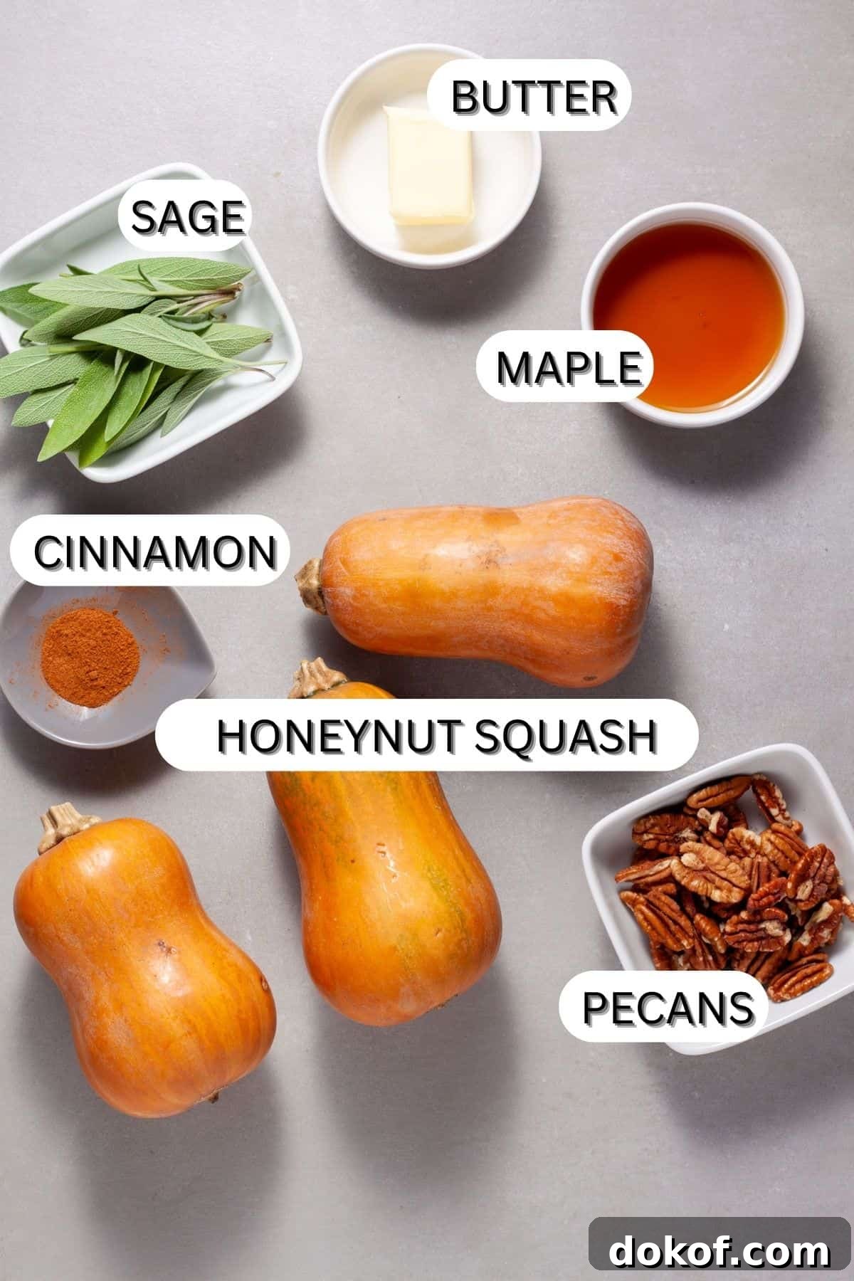 Ingredients for roasted honeynut squash with pecans and sage on a gray table.