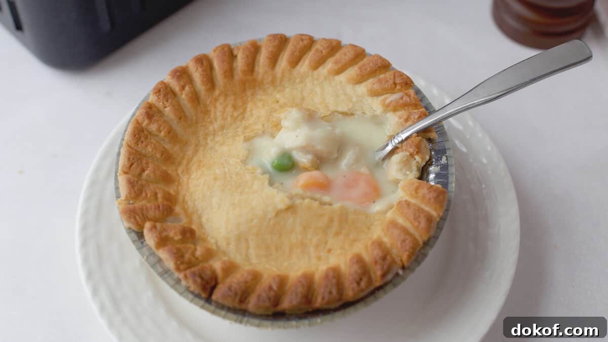 Pot pie on plate with fork in middle.