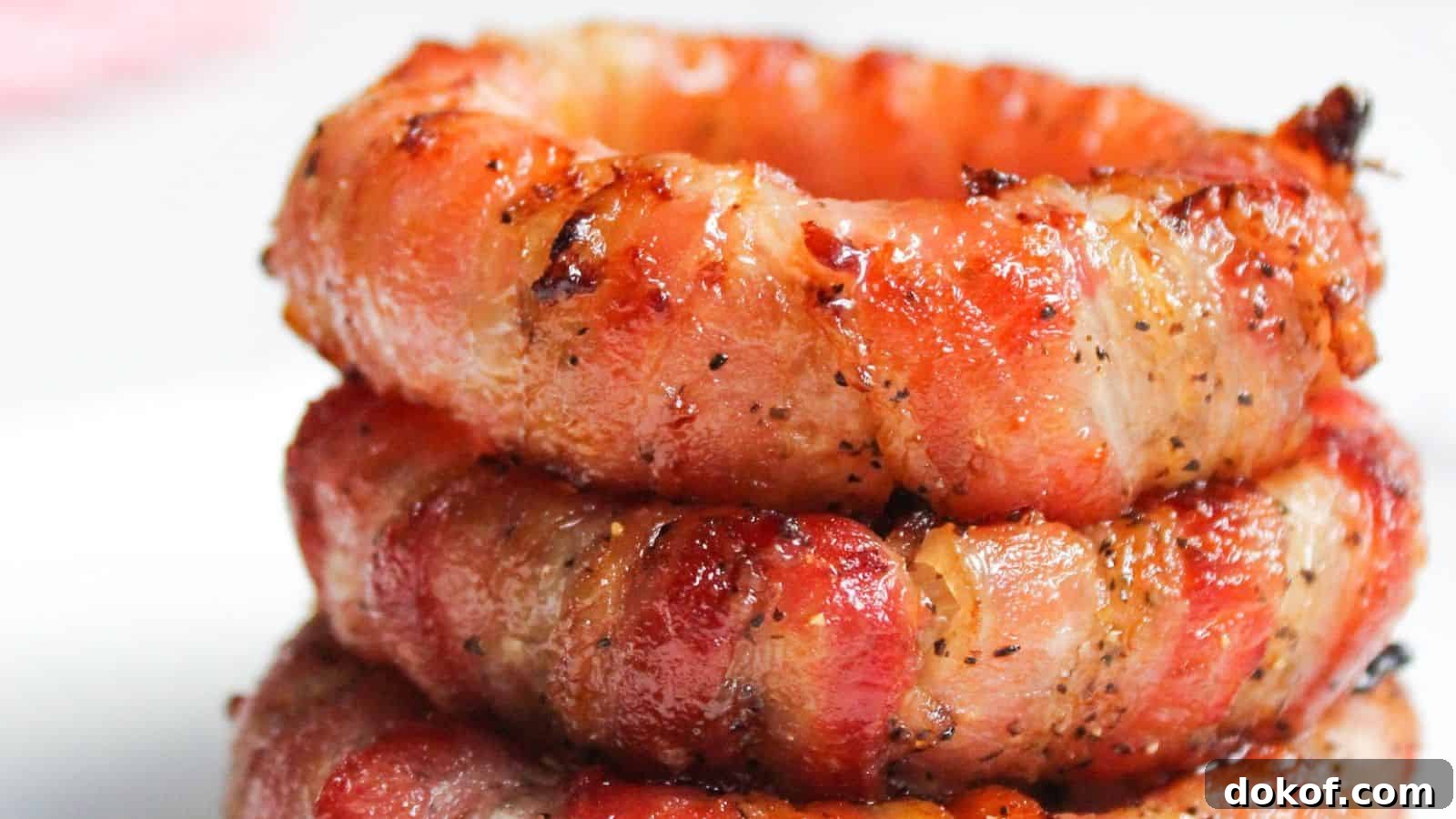 Stack of bacon wrapped onion rings.