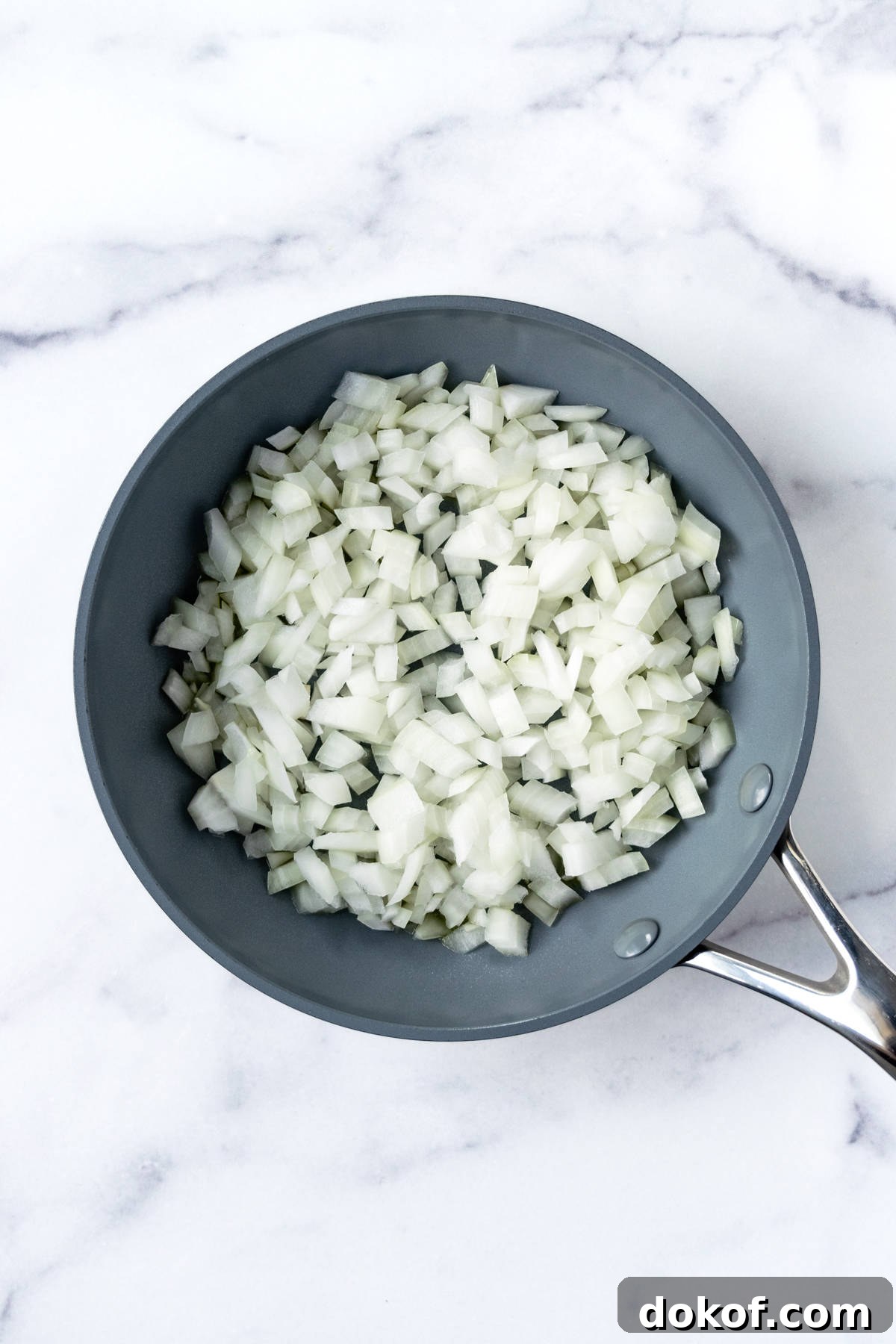 Diced onions in a non stick skillet.