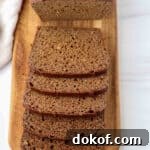 Kavring bread sliced on a wooden cutting board.