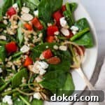 Spinach, asparagus and red pepper salad on a plate.