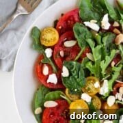 Swedish Marinated Tomato and Goat Cheese Salad next to a fork and napkin.
