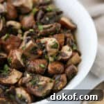Close up of Easy Quick Pickled Mushrooms in a white bowl.