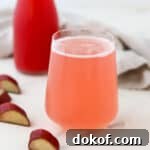 close up of glass of rhubarb syrup (cordial) and sparkling water.