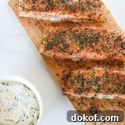 Salmon filets on a cedar plank with a creamy sauce