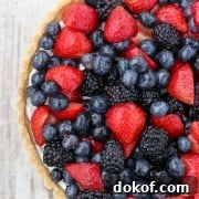A skyr tart with fresh berries on a wooden surface