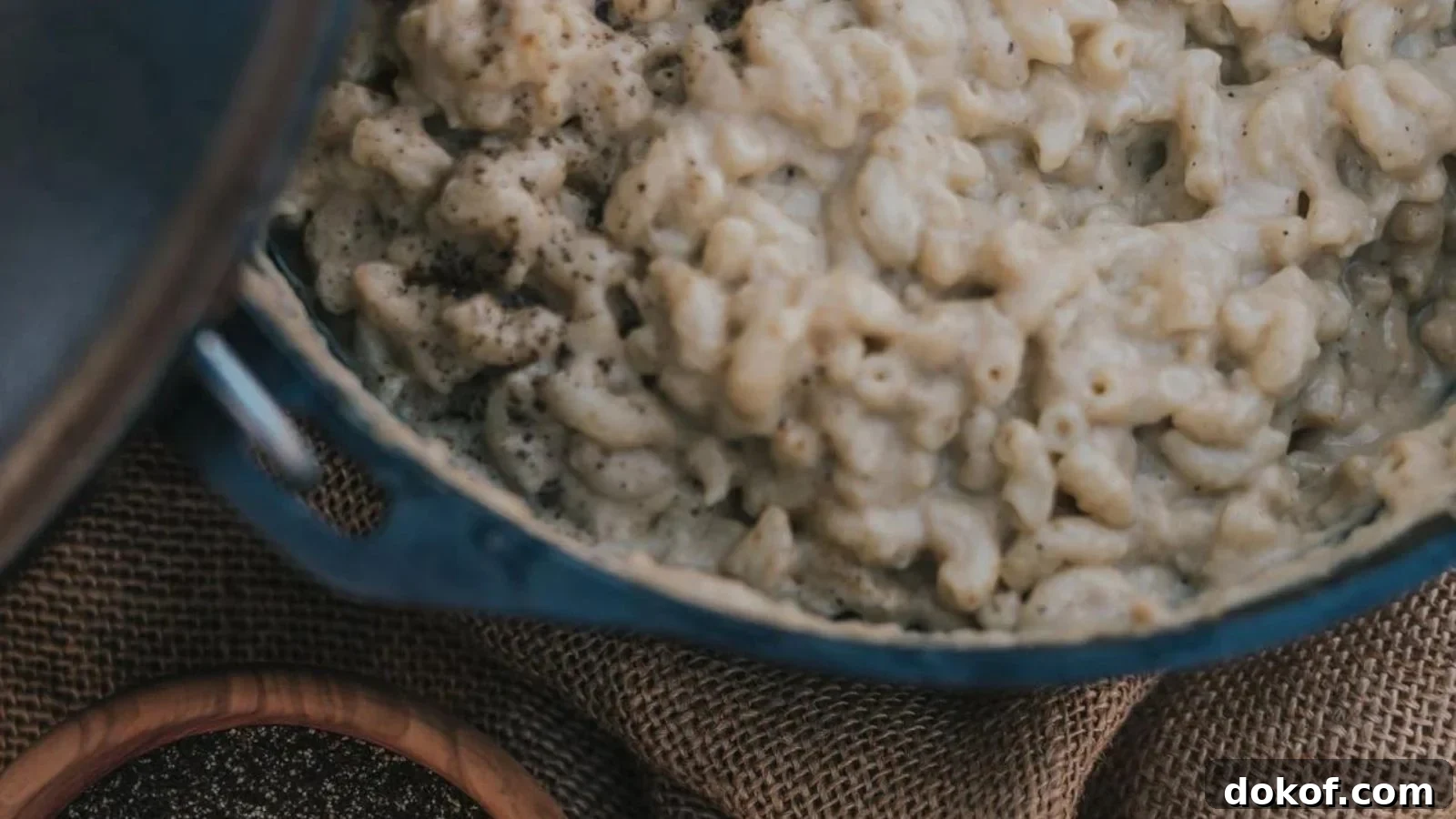 Dutch oven mac and cheese with a browned top and creamy noodles.