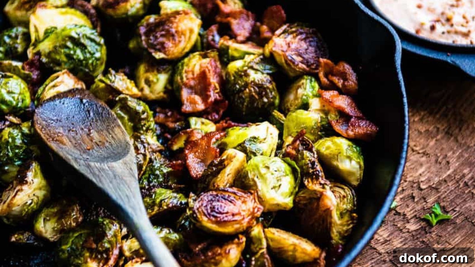 Smoked Brussels sprouts glazed in BBQ sauce with crispy bacon pieces.