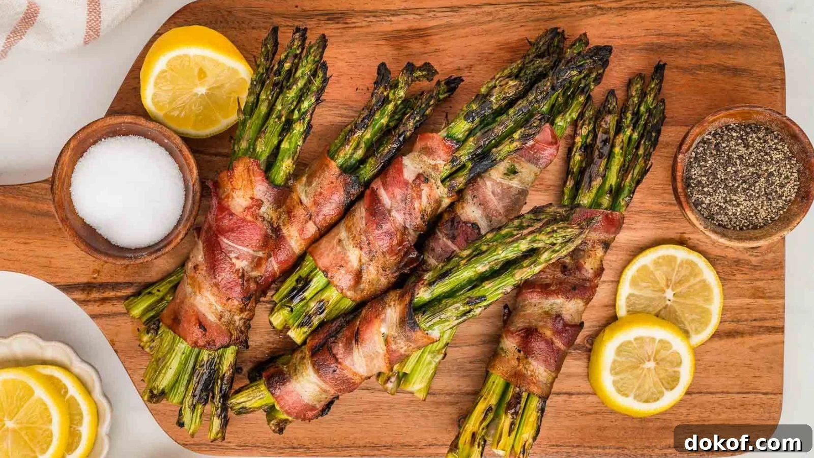 Grilled asparagus wrapped in bacon with charred edges and juicy centers.